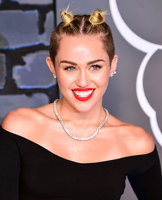 Miley Cyrus strutted the 2013 VMA red carpet with her unique, and now iconic, top knot 'do.