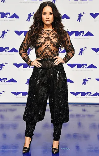 On the 2017 VMA red carpet, Demi Lovato paired a sheer lace top with sequin harem pants for a look that screams glam.