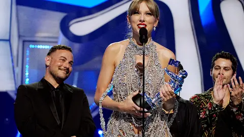 Taylor Swift accepts a Moon Person trophy at the 2022 MTV VMAs.