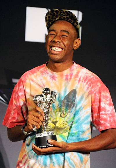 Musician, madman and mastermind behind Odd Future, Tyler, The Creator shows off his gold grill and silver Moonman after winning 2011's Best New Artist statuette.