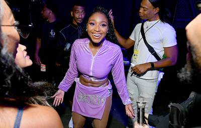 Singer Normani sports a wide grin backstage at the 2019 VMAs.