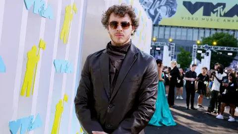Jack Harlow poses in leather on the black carpet of the 2022 MTV VMAs.