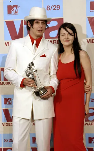 Jack and Meg of The White Stripes pose simply with their Moonman to match the elegant prom-night pose they're rocking at the 2002 MTV Video Music Awards.