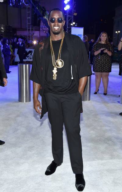Sean “P. Diddy” Combs looks suave in his all-black look, accented by layered gold chains on the 2016 VMA Red Carpet.