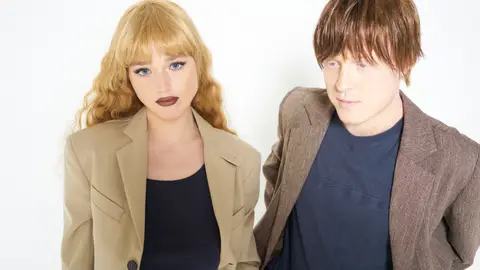 The British indie electronic duo Jockstrap wearing sport coats against a bright white background