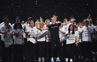 Logic and Ryan Tedder perform “One Day” with immigrant families at the center of their performance on stage sending a powerful message at the 2018 VMAs.