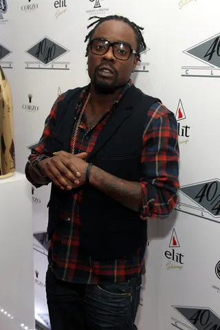 Wale  - The DC native rapper was a casual cutie during the night in a denim look with a flannel shirt and vest and his locs pulled up into a ponytail.   (Photo: Neilson Barnard/Getty Images)