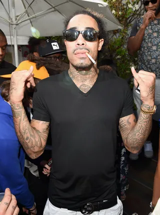 Guns On Display - Gunplay shows off his guns — and the tats covering them — while enjoying a smoke break. (Photo: Jason Merritt/Getty Images for Tidal/Roc Nation)