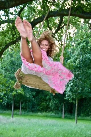 Carefree - The singer can't help but smile as she channels her inner girl on a swing set.&nbsp; (Photo: Courtesy of Iambeyonce Tumblr)