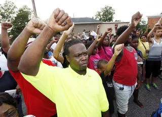 Fists Up - The faces of the young and old who demonstrated at a rally in remembrance&nbsp;of Jonathan Sanders. &nbsp;  (Photo: AP Photo/Rogelio V. Solis)