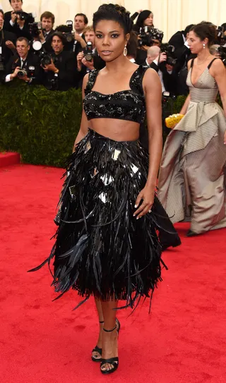 Gabrielle Union - The Being Mary Jane star lets her embellished Prada crop top and feathered skirt do all the talking. We likey.   (Photo: Larry Busacca/Getty Images)