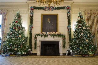 State Dining Room - The State Dining Room trees stand 14-feet tall and are decorated with vintage Union Pacific toy train pieces. Volunteers made the ornaments on the mantel that resemble Scrabble pieces that spell out &quot;winter wonderland.&quot;   (Photo: AP Photo/Evan Vucci)