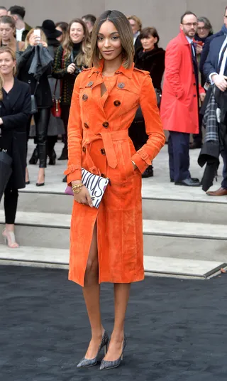 Pretty as a Peach - Jourdan Dunn&nbsp;gives a knowing smile in a fabulous orange suede trench coat outside the Burberry Prorsum show at the London Collections: Men AW15 in London.(Photo: Anthony Harvey/Getty Images)