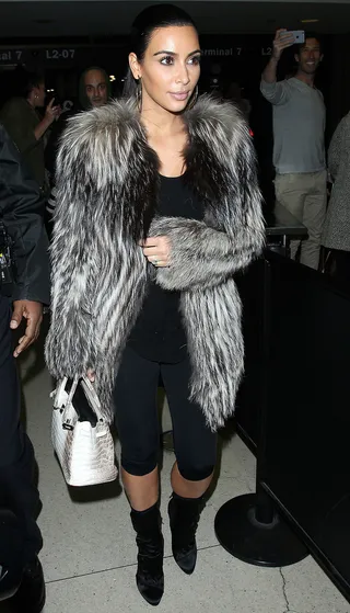 Flurry and Fur - Kim Kardashian arrives at Los Angeles International Airport in a lush fur while being bombarded by a fury of flashing lights. &nbsp;(Photo: Splash News)