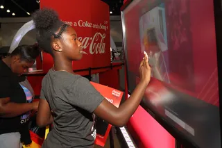 More Coca-Cola - This young lady gets a free Coca-Cola at the Coke Music station. (Photo: Tommaso Boddi/BET/Getty Images for BET)&nbsp;