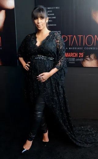 Leather and Lace - Kim Kardashian rubs her baby bump on the red carpet of her new movie premiere, Temptation, at AMC Parkway Pointe in Atlanta. (Photo: Paras Griffin /Landov)