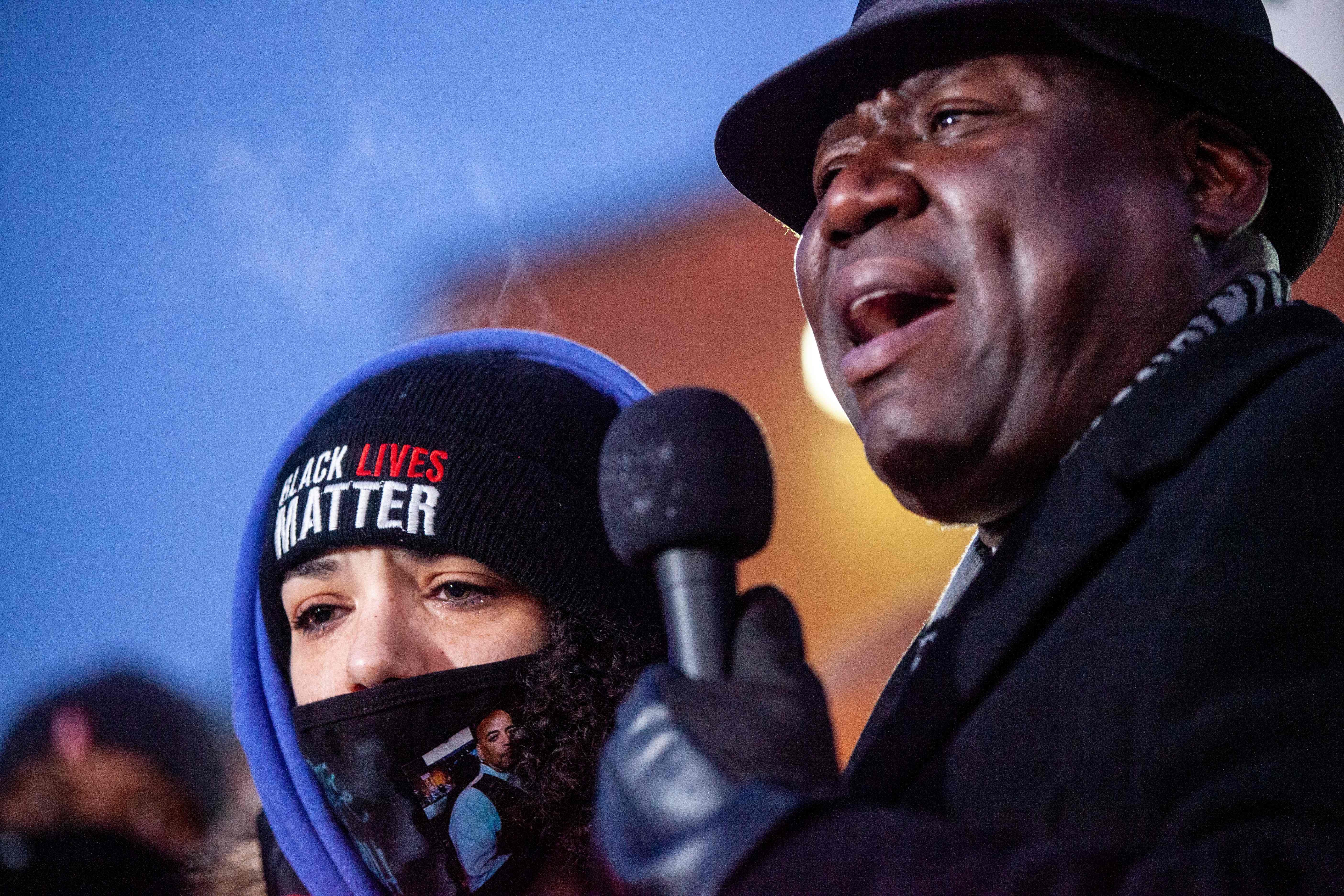 Attorney Ben Crump addresses the crowd next to Andre Hills daughter, Karissa Hill, at a press conference and candlelight vigil for Andre Hill outside the Brentnell Community Recreation Center in Columbus, Ohio on December 26, 2020. - The fatal shooting of an unarmed Black man by police in  Columbus, Ohio -- the US city's second such killing this month -- sparked a fresh wave of protests on December 24 against racial injustice and police brutality in the country. Andre Maurice Hill, 47, was in the garage of a house on the night of December 21 when he was shot several times by a police officer who had been called to the scene for a minor incident. (Photo by STEPHEN ZENNER / AFP) (Photo by STEPHEN ZENNER/AFP via Getty Images)