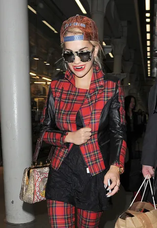 Rad Plaid - Rita Ora arrives at St. Pancras Station on a Eurostar train from Paris beaming as she shows off her new black grills.(Photo: Squirrel / Splash News)