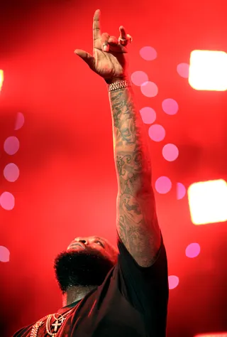 Deeper Than Rap - Rick Ross ends his performance at the 2014 BET Experience with a quick spiritual thanks and points to the sky in praise.&nbsp; (Photo: Christopher Polk/BET/Getty Images for BET)