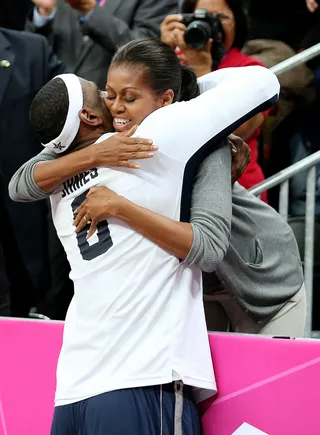 Proud First Lady - Obama cheers on the USA Basketball Dream Team and gets a hug from antother player.&nbsp; (Photo: Jean Catuffe, PacificCoastNews.com)