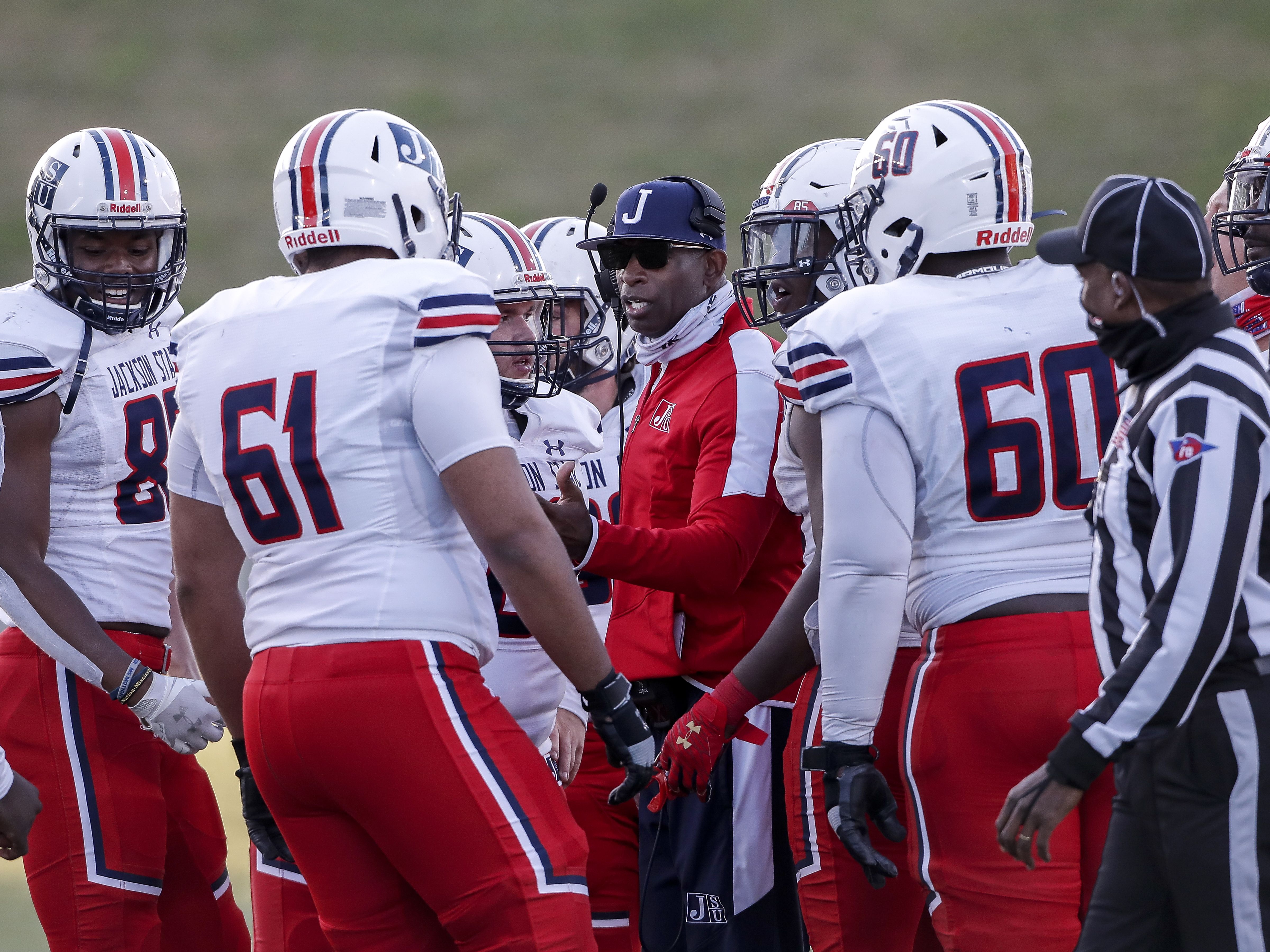 MONTGOMERY, AL - MARCH 20: Head Coach Deion Sanders of the Jackson State Tigers talk with his team during a time out during the game against the Alabama State Hornets at New ASU Stadium on March 20, 2021 in Montgomery, Alabama. Alabama State Hornets defeated the Jackson State Tigers 35 to 28. (Photo by Don Juan Moore/Getty Images) *** Local Caption *** Deion Sanders