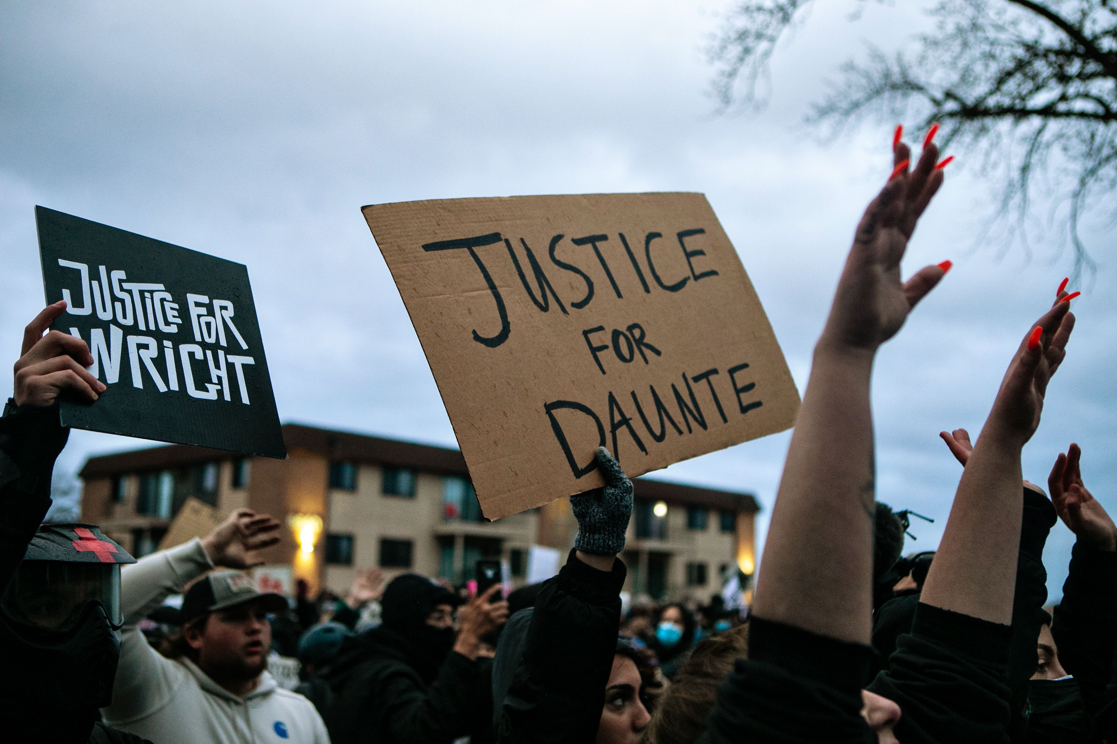 BROOKLYN CENTER, MN - APRIL 14: Protesters gather outside the Brooklyn Center Police Department calling for justice for Daunte Wright before curfew on Wednesday, April 14, 2021 in Brooklyn Center, MN. (Jason Armond / Los Angeles Times)