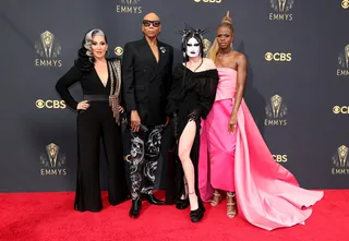 RuPaul - The star of the namesake show “RuPaul’s Drag Race” wore a classic black blazer with a studded lapel pin and marbleized black and white pants. He brought the look together with a black clutch and moody shades.&nbsp; (Photo: Rich Fury/Getty Images)