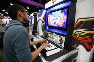 One-on-One - This guest got into the game as other attendees looked on. (Photo: Tommaso Boddi/Getty Images for BET)