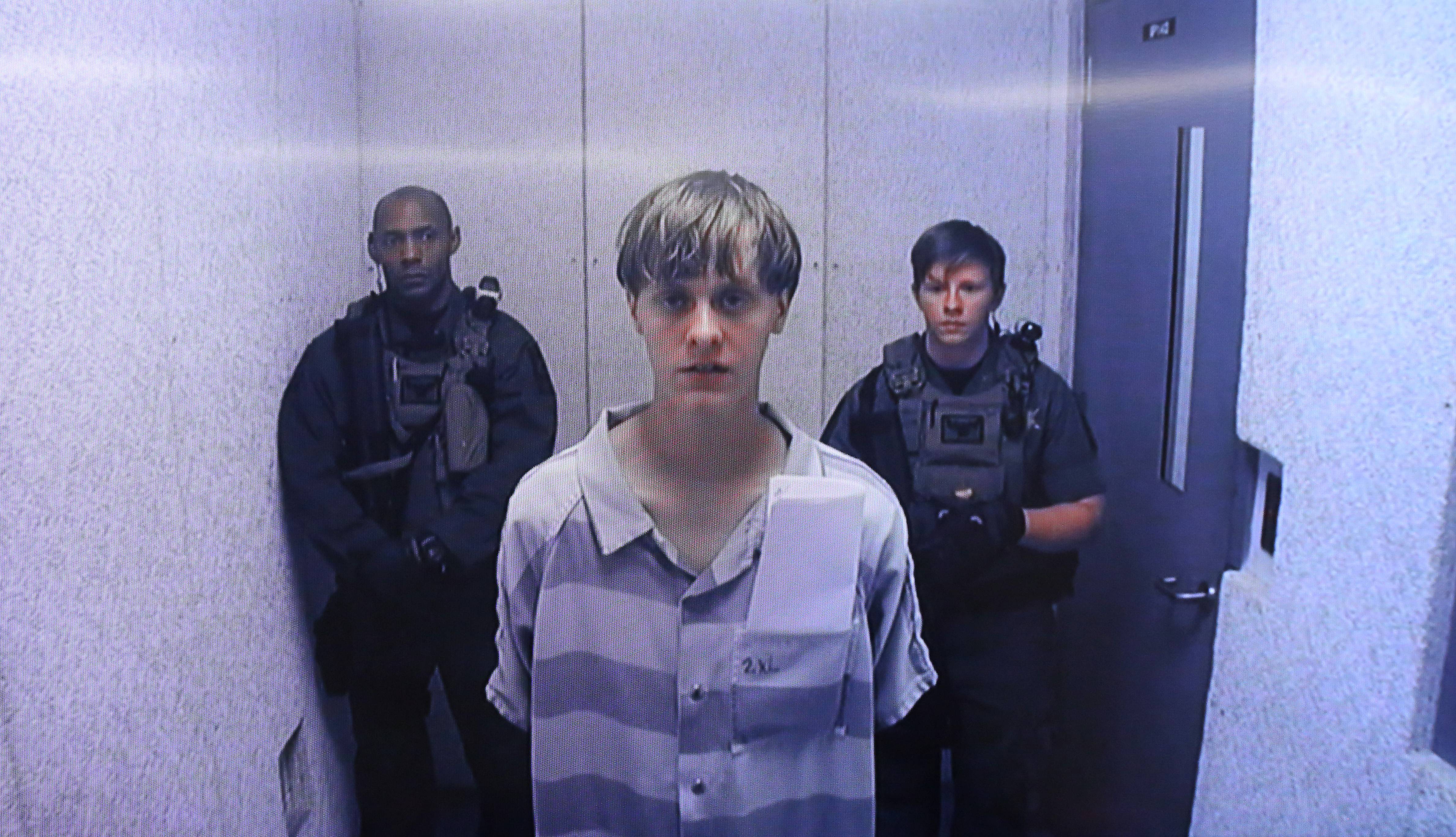 NORTH CHARLESTON, SC - JUNE 19:  In this image from the video uplink from the detention center to the courtroom, Dylann Roof appears at Centralized Bond Hearing Court June 19, 2015 in North Charleston, South Carolina. Roof is charged with nine counts of murder and firearms charges in the shooting deaths at Emanuel African Methodist Episcopal Church in Charleston, South Carolina on June 17. (Photo by Grace Beahm-Pool/Getty Images)