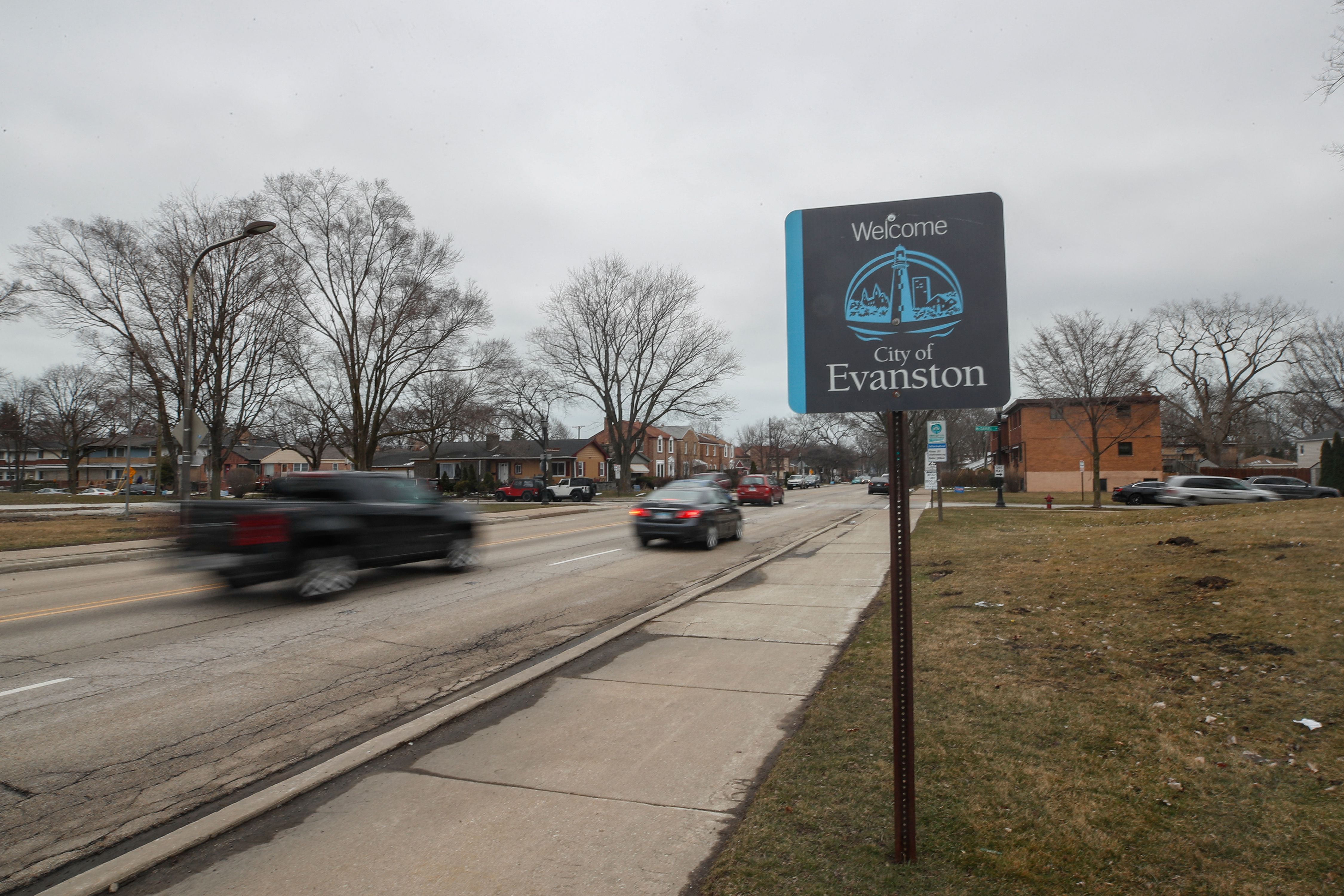 Cars drive past a sign welcoming people to the city of in Evanston, Illinois, on March 16, 2021. - A suburb in Chicago is set to become the first place in the United States to provide reparations to its Black residents, with a plan to distribute $10 million over the next decade. Evanston, home to Northwestern University and just north of Chicago along the shore of Lake Michigan, will have a city council vote March 22 on the issue, which is expected to pass. (Photo by KAMIL KRZACZYNSKI / AFP) (Photo by KAMIL KRZACZYNSKI/AFP via Getty Images)