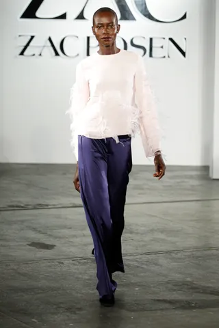 ZAC Zac Posen Collection - Flirty ostrich-feather accents take this soft pink sweater over the top and complement the vivid violet hue of the trousers. Werk!  (Photo: Thomas Concordia/WireImage)