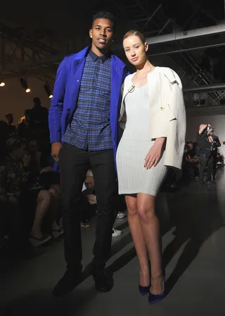 Coordinate - The pair wore complementary looks when they sat front row for Calvin Klein’s Menswear presentation at Milan Fashion Week. His cobalt jacket covered a black-and-blue button-down shirt. She wore a white leather topper over a body-conscious sheath. Her pumps tied together the color story.&nbsp; (Photo: Pier Marco Tacca/Getty Images)