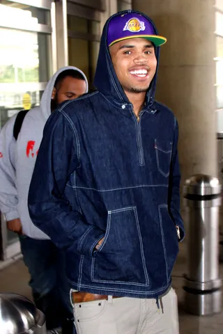 Fame Game - Chris Brown couldn't be more excited after arriving at D.C.'s Ronald Reagan National Airport to promote his new album F.A.M.E..  (Photo: Mark Wilkins/WENN.com)