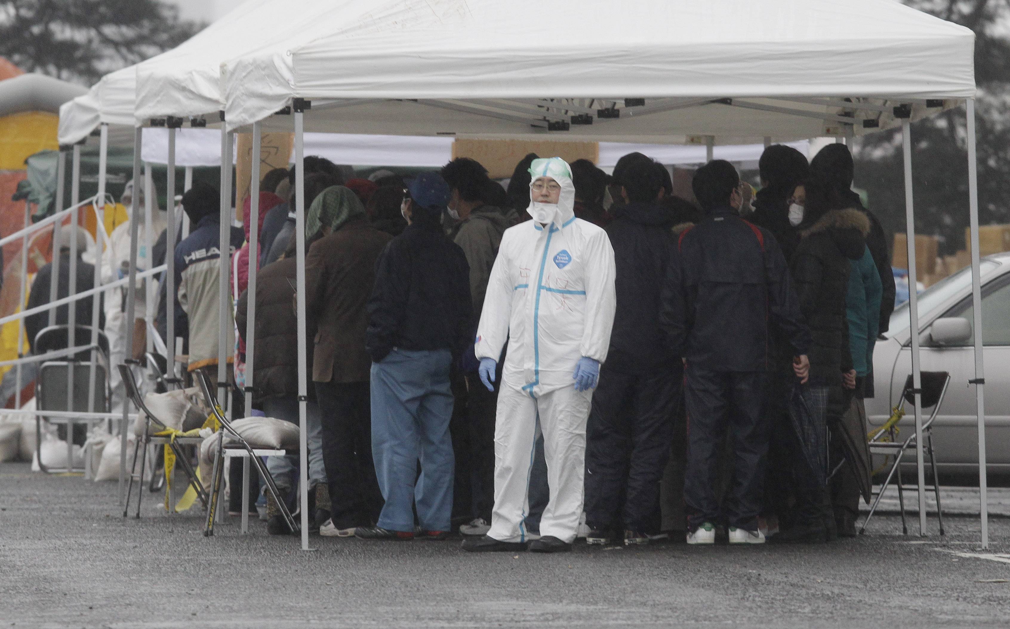 Japanese Tsunami Aftermath - The devastating effects of Friday’s 8.9 magnitude quake in Japan that triggered tsunamis are still being felt. Japan ordered 140,000 people to stay indoors after dangerously high levels of radiation began leaking from the Fukushima Dai-ichi nuclear complex after a third explosion Tuesday. The nation’s prime minister warned that more leaks could occur. In this image, people line up at a radiation emergency scanning center in Koriyama, Japan, Tuesday. (Photo: AP Photo/Mark Baker)