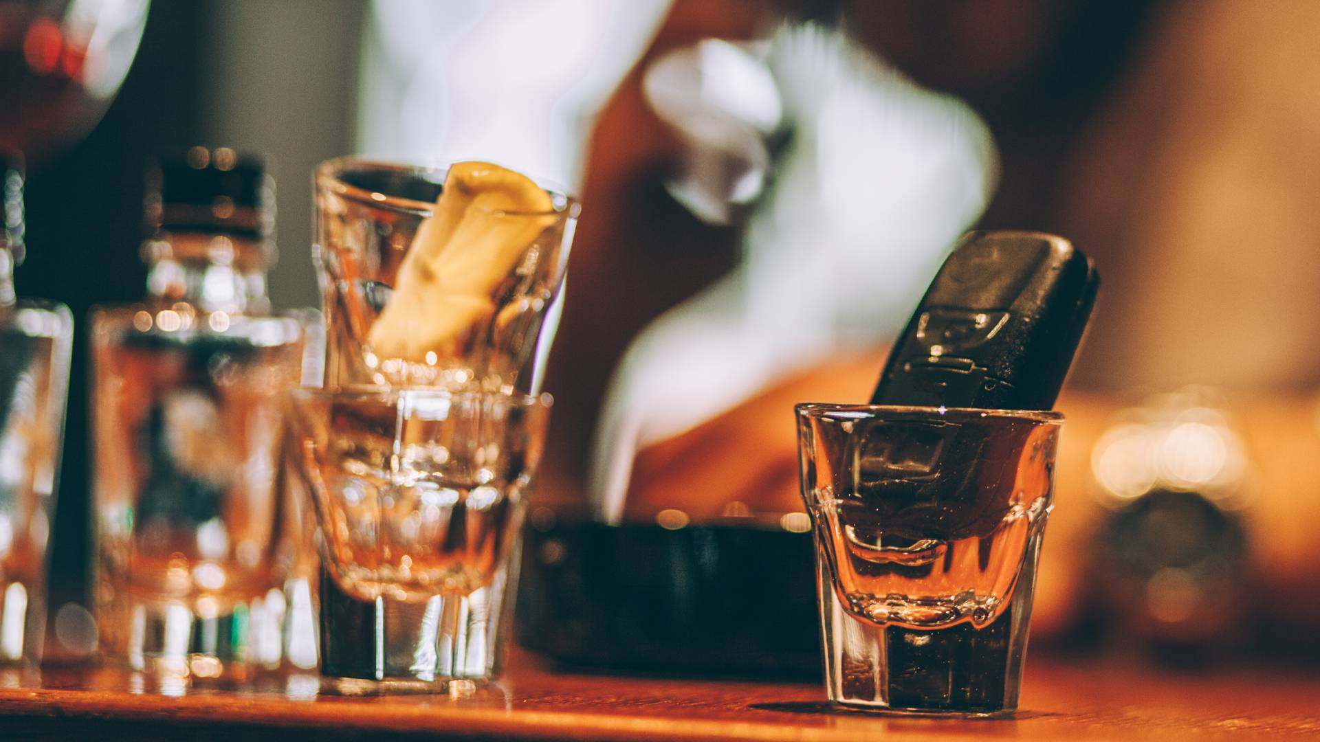 Young drunk man sitting in pub and holding car key