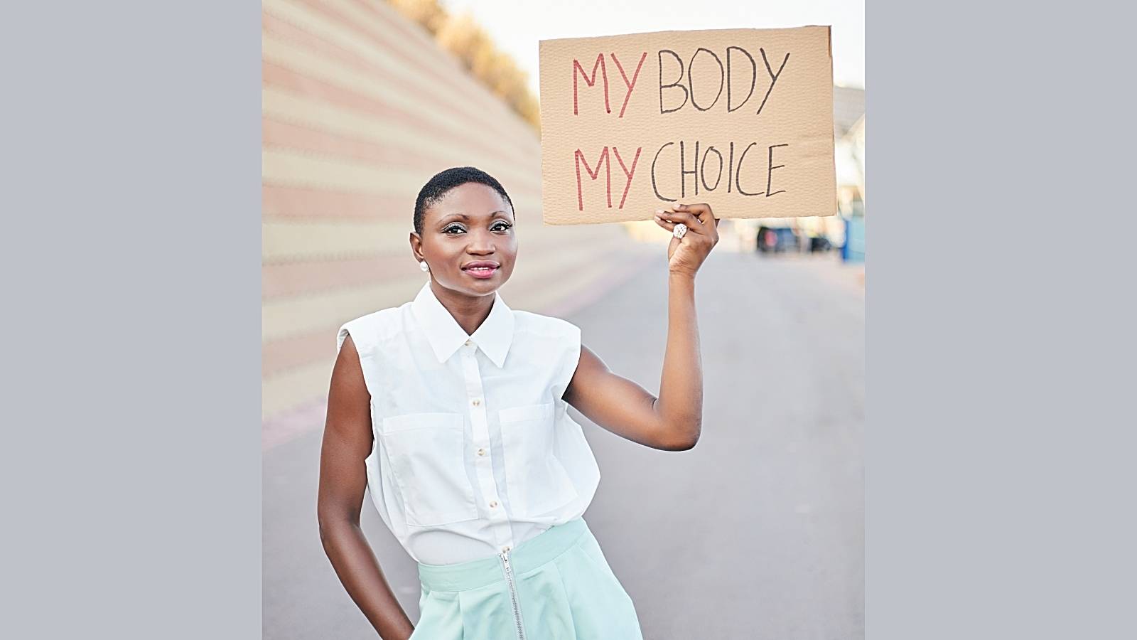 Black woman protesting for women's equality and rights.