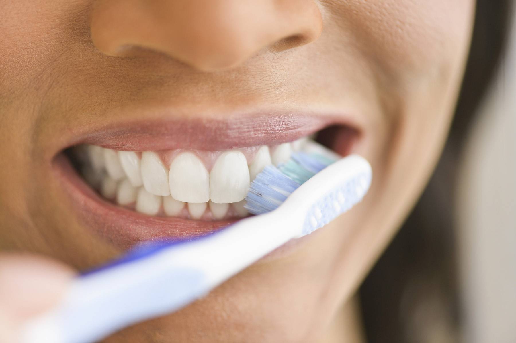 woman brushing her teeth