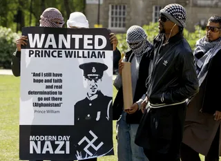 Protests - Islamic protestors hold banners as they speak with London media Wednesday. The protestors have been banned by police from demonstrating during the royal&nbsp;wedding. (Photo: AP Photo/Kirsty Wigglesworth)