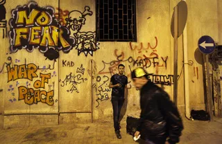 Pro-Opposition Graffiti - Libyan youth hang out at night in a street whose walls are covered with pro-revolutionary graffiti in Benghazi.(Photo: AP Photo/Ben Curtis)