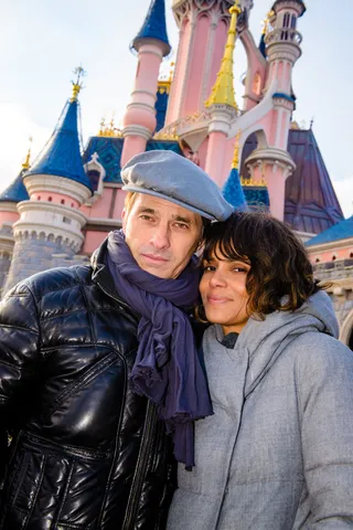 Love In the Magic Kingdom - Halle Berry and husband Olivier Martinez enjoy a romantic day at Disneyland Paris snapping photos in front of Sleeping Beauty's Castle and inside Christmas in the Park.(Photo: FameFlynet, Inc)