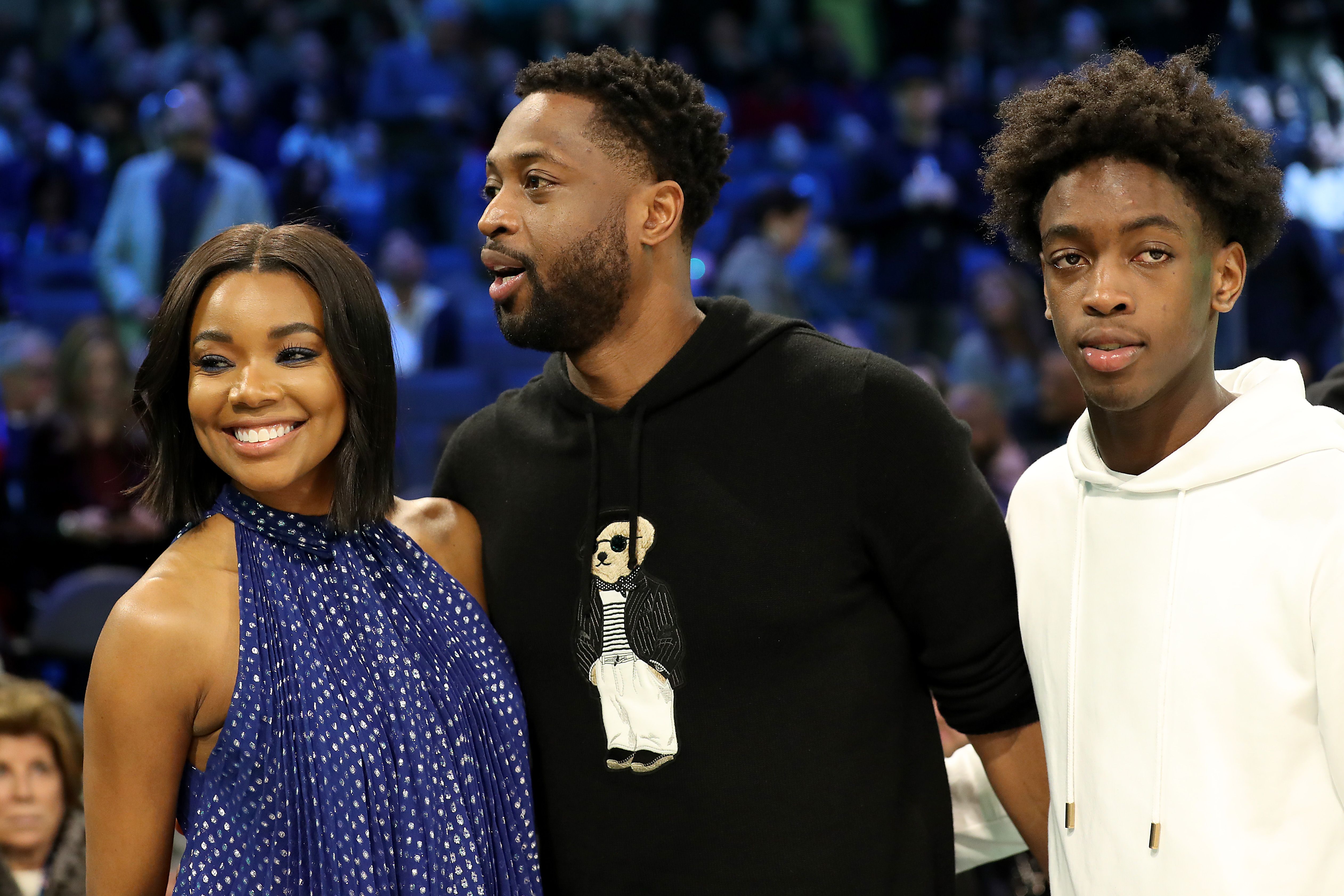 CHARLOTTE, NORTH CAROLINA - FEBRUARY 16: Dwyane Wade (C), wife Gabrielle Union-Wade (L) and son Zaire (R) look on during the MTN DEW 3-Point Contest as part of the 2019 NBA All-Star Weekend at Spectrum Center on February 16, 2019 in Charlotte, North Carolina. (Photo by Streeter Lecka/Getty Images)