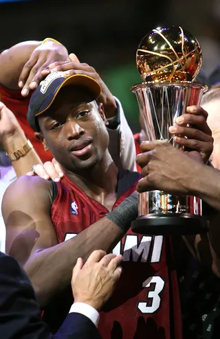 Dwyane Wade - 2006 - Can you say sitting on top of the world? That's how it must have felt for a then 24-year-old Dwyane Wade to lead the Miami Heat to a 2006 NBA Finals win for his first championship. D. Wade also claimed the Finals MVP.&nbsp;(Photo: Ronald Martinez/Getty Images)