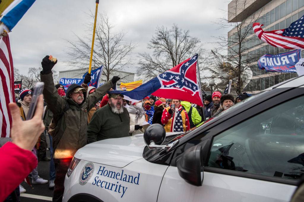 WASHINGTON, DISTRICT OF COLUMBIA, UNITED STATES - 2021/01/06: US President Donald Trump’s supporters push back a police car while gathering outside the Capitol Building. Pro-Trump rioters stormed the US Capitol as lawmakers were set to sign off Wednesday on President-elect Joe Biden's electoral victory in what was supposed to be a routine process headed to Inauguration Day. (Photo by Probal Rashid/LightRocket via Getty Images)