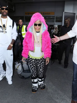 Nicki Sad Face - Nicki Minaj doesn't look too happy in this zany mix-match get-up as she arrives with her entourage at London's Heathrow airport. The rap star recently closed her Twitter account due to an influx of negative comments from followers.   (Photo:Optic Photos, PacificCoastNews.com)
