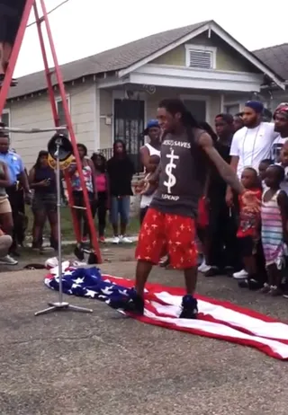 Lil’ Wayne on trampling over the flag during a video shoot for the song “God Bless Amerika”:&nbsp; - "I didn't step on the flag on purpose! It's a scene in a video where the flag drops behind me and after it drop it's just there as I perform.”  (Photo: YouTube via Volvodea1)