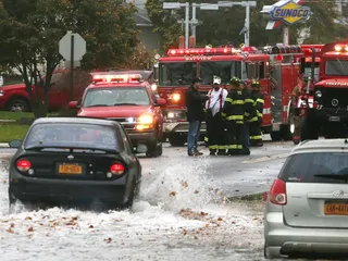 First Responders - Members of the Bayview Hose Company No. 3 of the Freeport Fire Department survey the situation on South Long Beach Avenue on Monday.&nbsp; (Photo: Bruce Bennett/Getty Images)