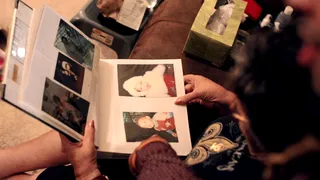 Baby Dee-1 - Dee-1 sits with grandma as she flips through baby pics of the MC.&nbsp;(Photo: BET)