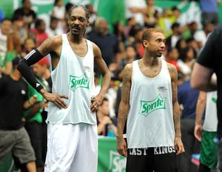 Cali Connection - Uncle Snoop Dogg (L) chops it up with his 'nephew' Tyga during a break in the action. (Photo: Noel Vasquez/BET/Getty Images for BET)