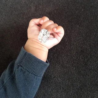 Kim Kardashian @kimkardashian - “It was an amazing year!!!” Reality TV Queen Kim Kardashian gets a sentimental shot of her mega-watt engagement ring from Yeezy in baby North’s hand.(Photo: Kim Kardashian via Instagram)