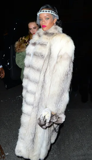 Who's Bad? - Rihanna hosted New Year's Eve at Jay Z's 40/40 club in NYC with a host of friends, including model Cara Delevingne (pictured here). Rih Rih wore an enormous white fur coat and a veil over her face upon her arrival. This pop diva knows how to bring the drama!&nbsp;(Photo: 247PapsTV / Splash News)